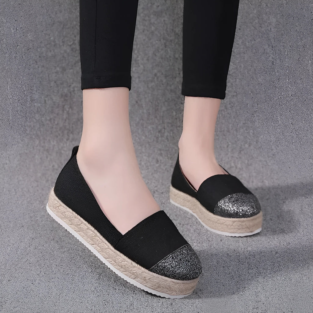Black plus size breathable canvas flat shoe with round toe and slip-on design.