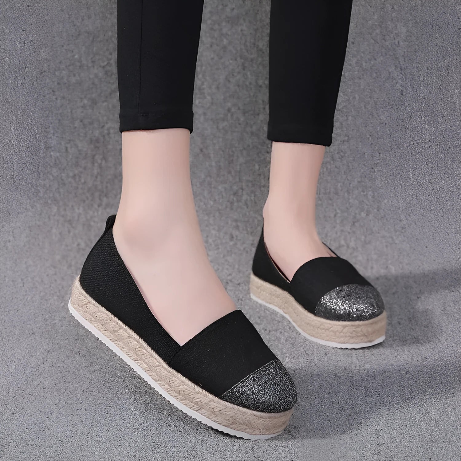 Black plus size breathable canvas flat shoe with round toe and slip-on design.
