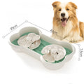 Large green slow feeder dog bowl with three rotating puzzle trays and anti-slip suction cups on base.