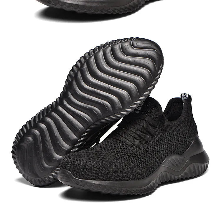 Black steel toe cap safety shoes with low-cut design on a work site background.