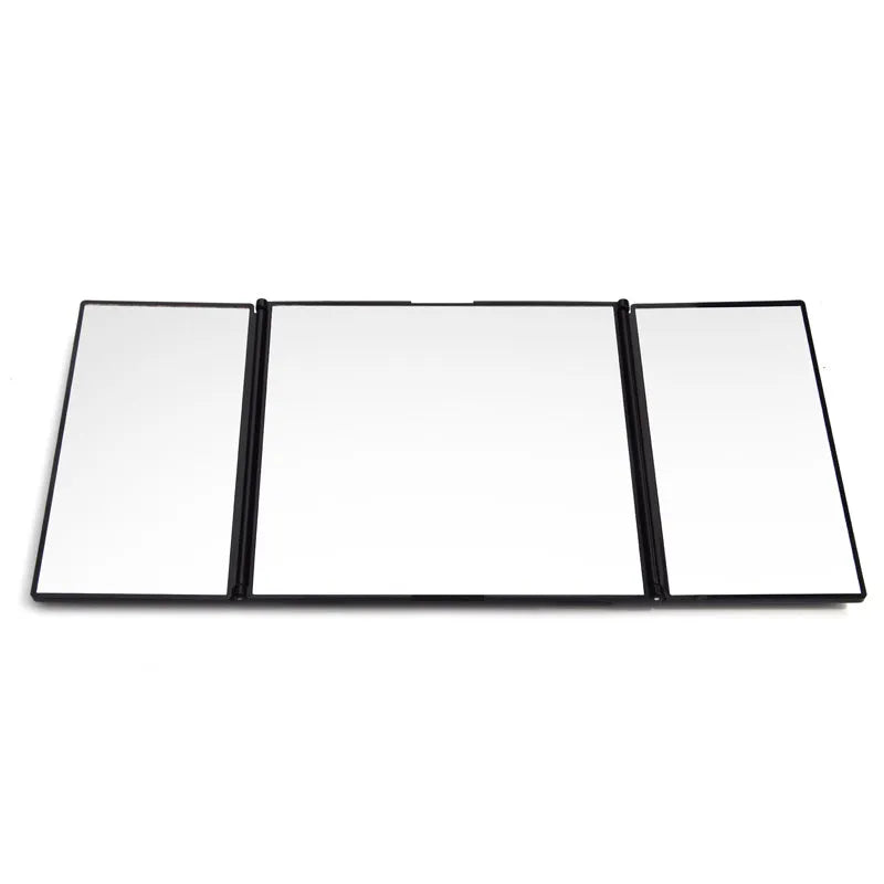 Silver car folding grooming mirror shown opened and closed on a car dashboard.
