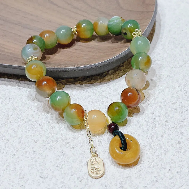 Yellow women's folk bracelet with peacock agate and topaz stones and a peace buckle clasp.