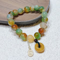 Yellow women's folk bracelet with peacock agate and topaz stones and a peace buckle clasp.