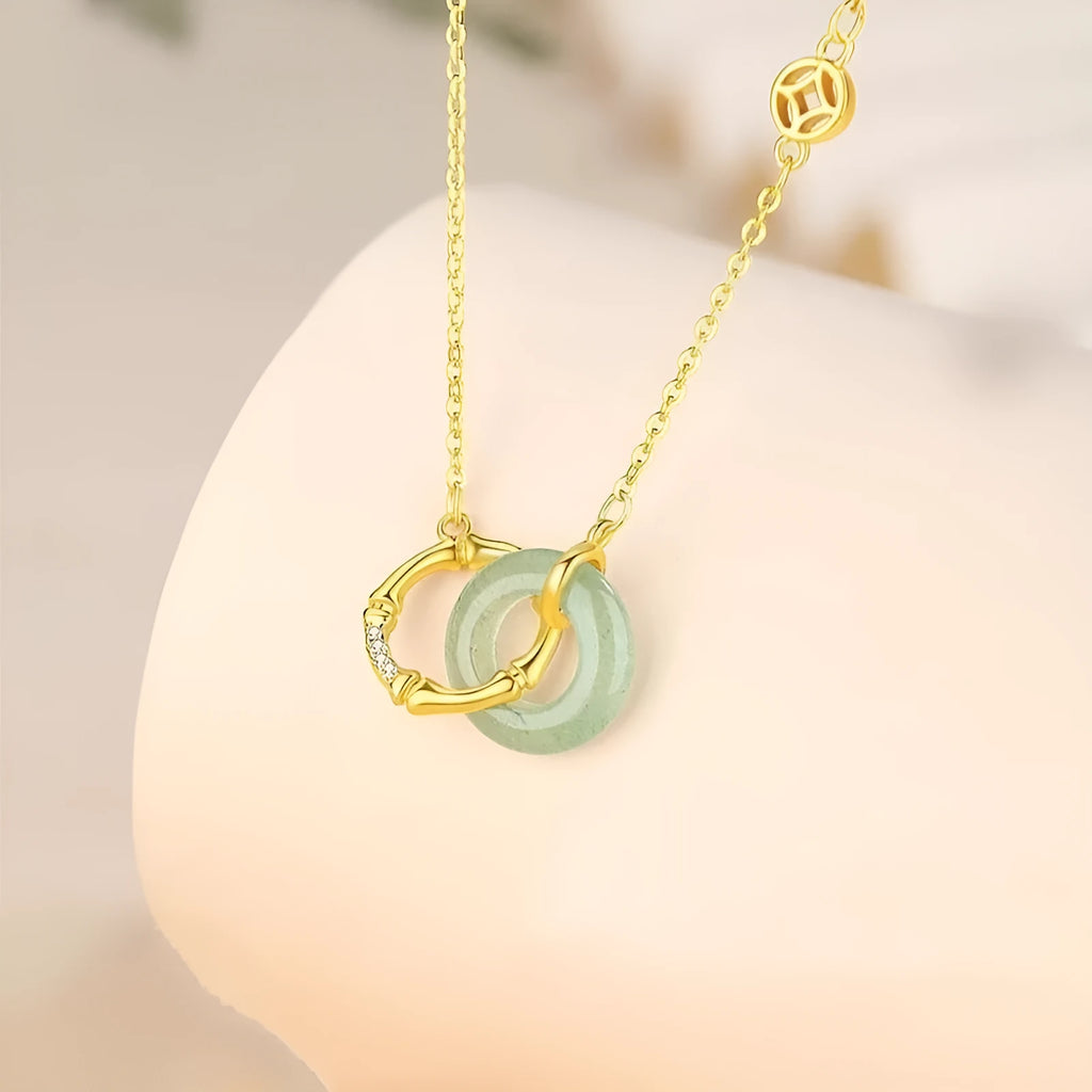 Handmade sterling silver bamboo joint peace buckle necklace with pearl details on an O-chain.