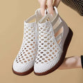 Gold and white women's flat sandals with hollow-out PU upper and soft TPR sole.