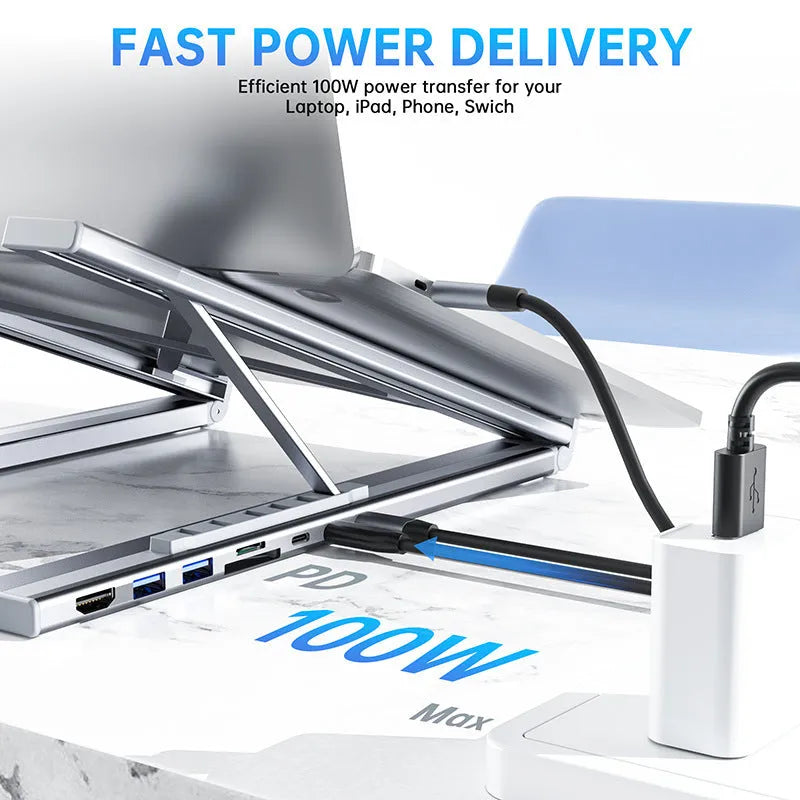 Aluminium alloy folding laptop docking station and stand in silver, shown with multiple USB and HDMI ports.