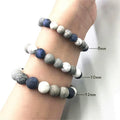 Handmade natural planet stone bracelet with starry design on a wrist, showing U-shaped profile.