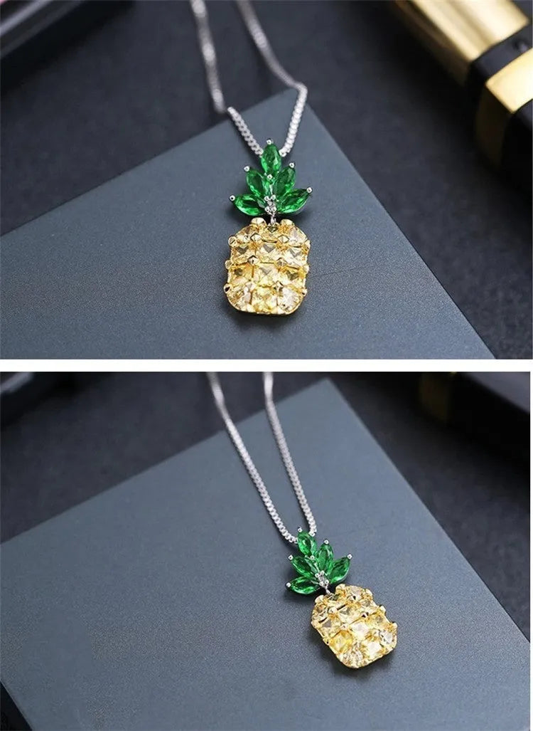 Silver geometric pineapple pendant necklace with diamond details on a model.