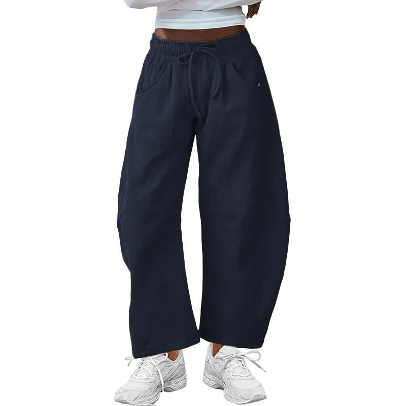 Loose cropped sports sweatpants with elastic waistband and drawstring pockets in street fashion style