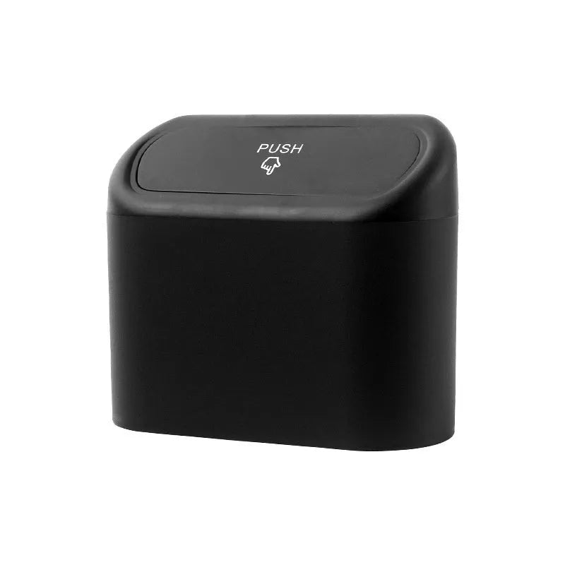 Black folding plastic car trash can shown in a vehicle footwell.