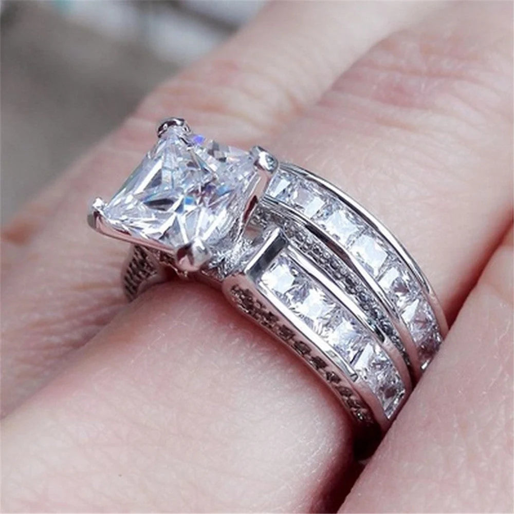 Silver charm couple rings with princess cut CZ, perfect for anniversaries, promises, or engagements