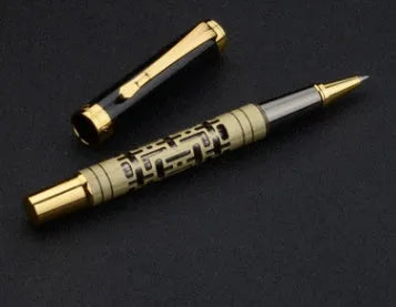 Yellow bronze metal fountain pen with iridium nib, 0.7mm big point, and gold trim, lying on a light surface