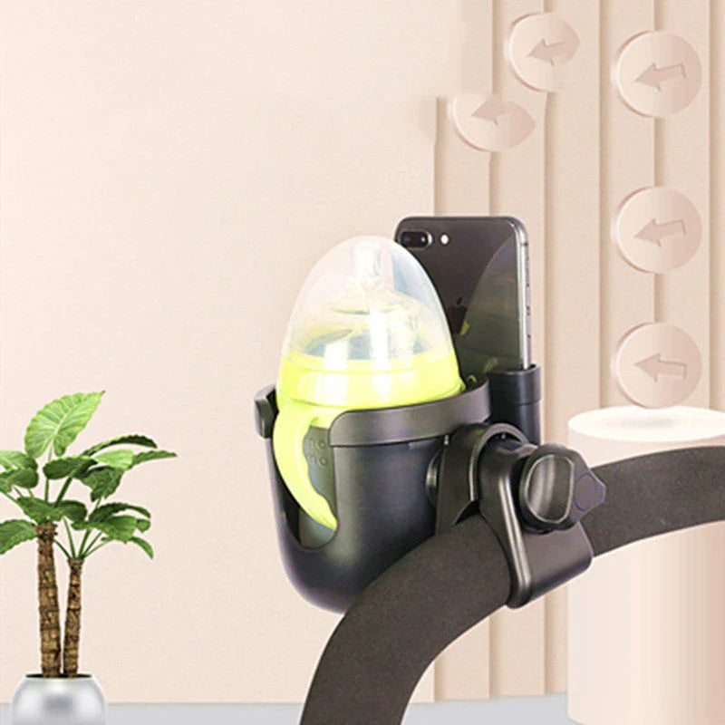 Universal baby stroller cup holder with phone pocket attached to a stroller