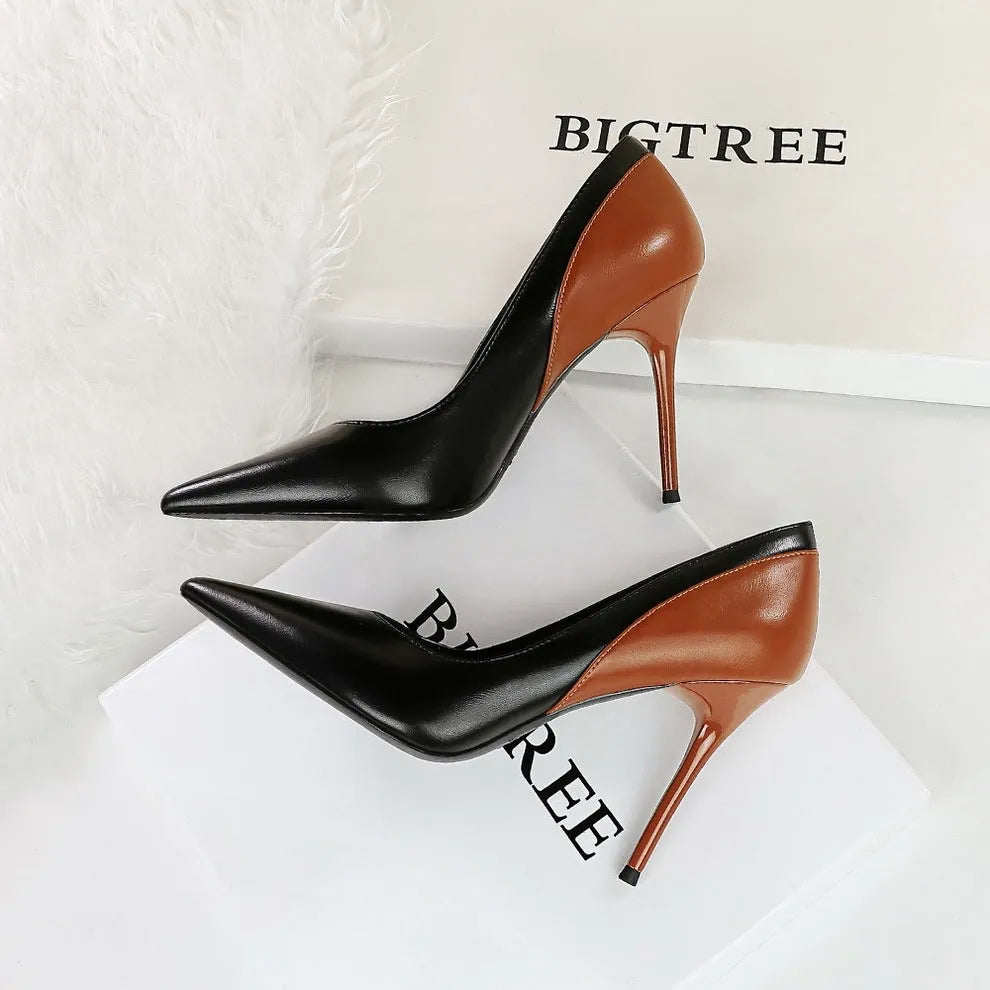 Women's black retro pumps with a pointed toe and high stiletto heel on a white background.