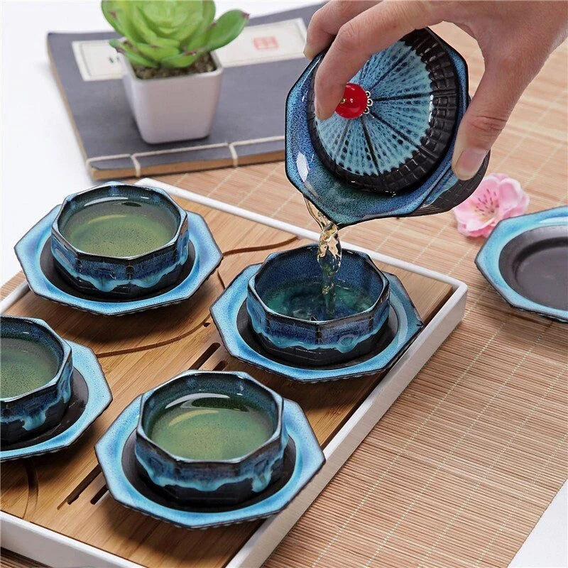 Stylish ceramic tea set with teapot, teacups, trays, and accessories for a portable and versatile tea experience