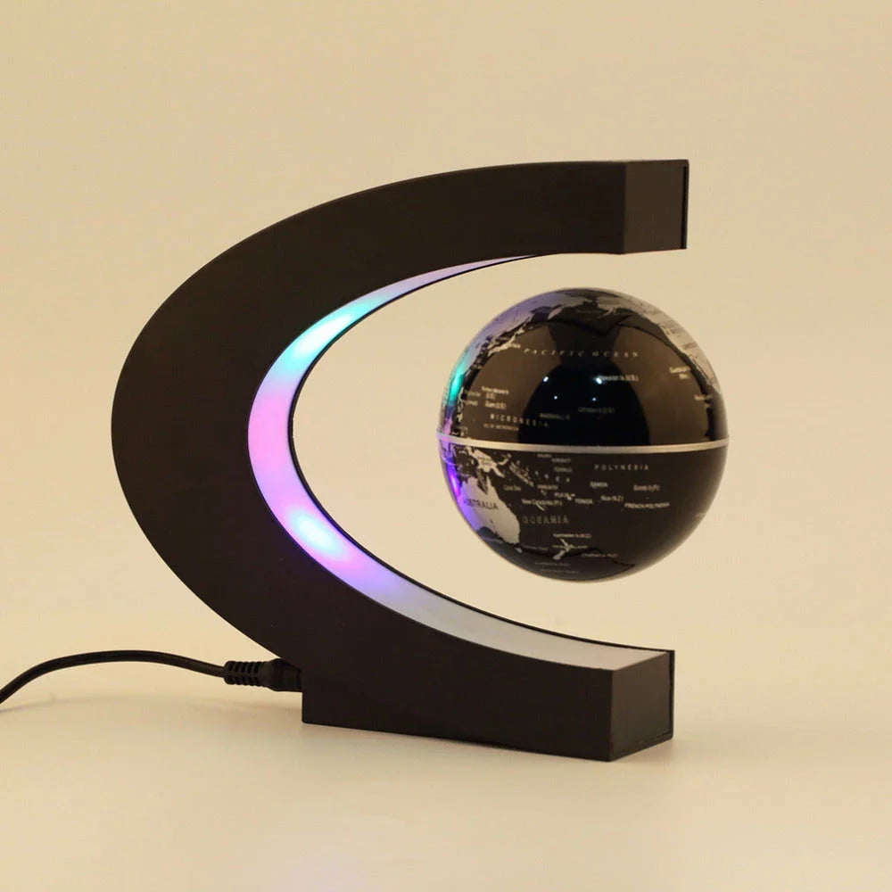 Magnetic levitation globe floating above base with LED light on