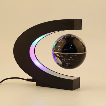 Magnetic levitation globe floating above base with LED light on