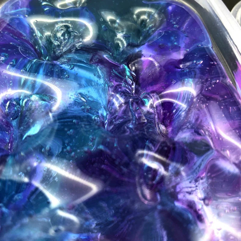 Gradient multicolor crystal mud slime in a plastic box, showcasing its vibrant colors and smooth texture