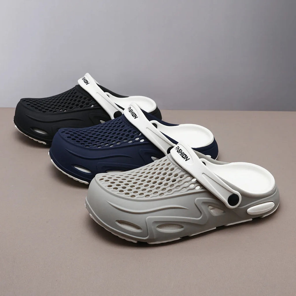 Men's grey closed toe EVA beach slippers with a non-slip sole and flat heel on a poolside.