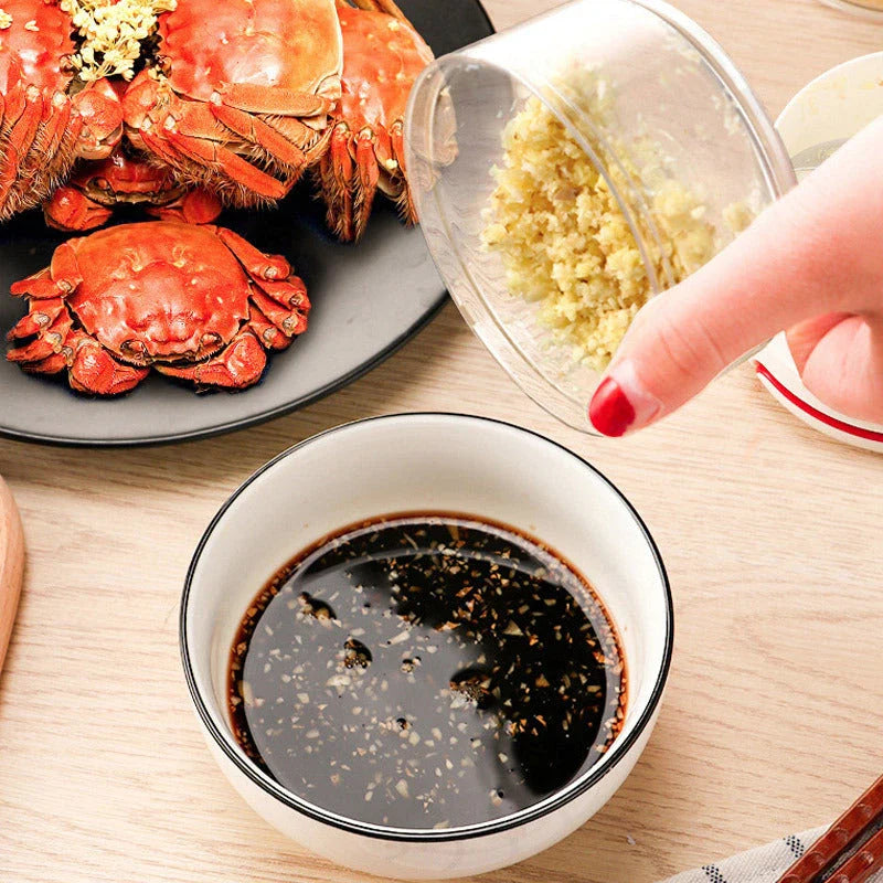 Manual cutting meat grinder with stainless steel blades on a kitchen counter