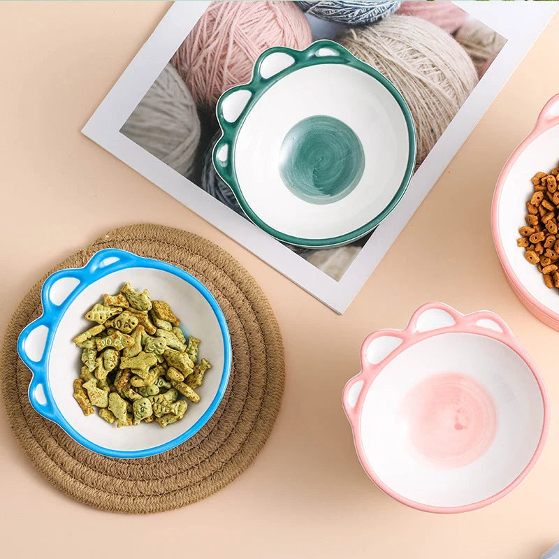 Ceramic pet bowl with cartoon paw design and 15-degree incline for comfortable feeding