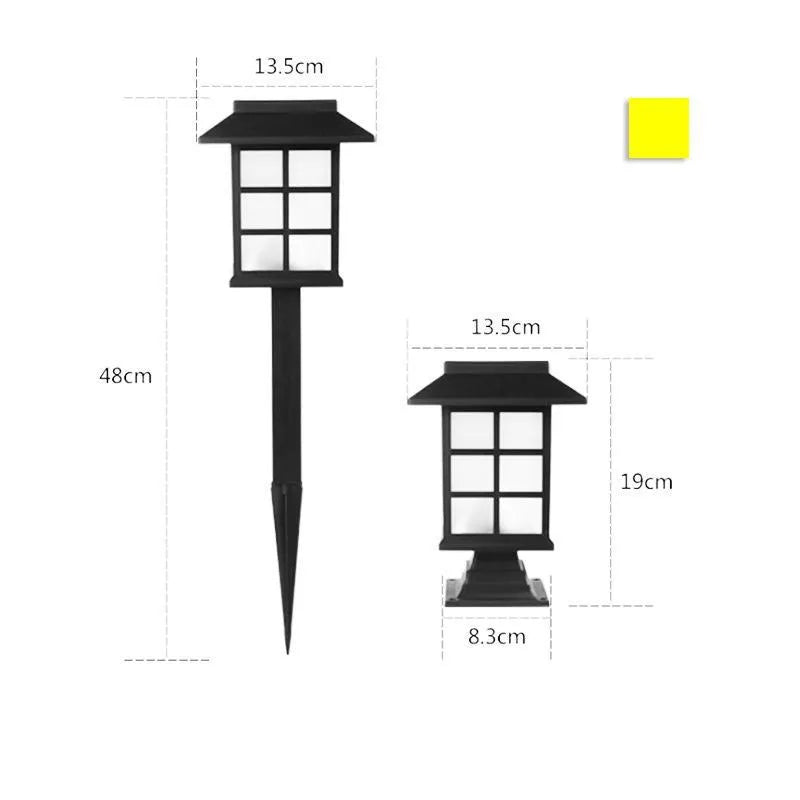 Black solar-powered outdoor LED lawn light with window-style openings, shown in a garden setting.