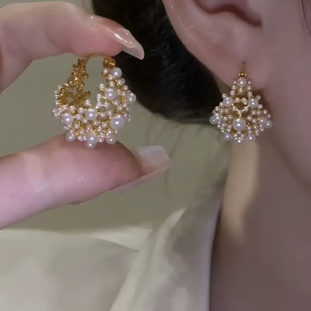 Gold-coloured copper flower basket earrings with small rice-shaped beads and pearl inlay details