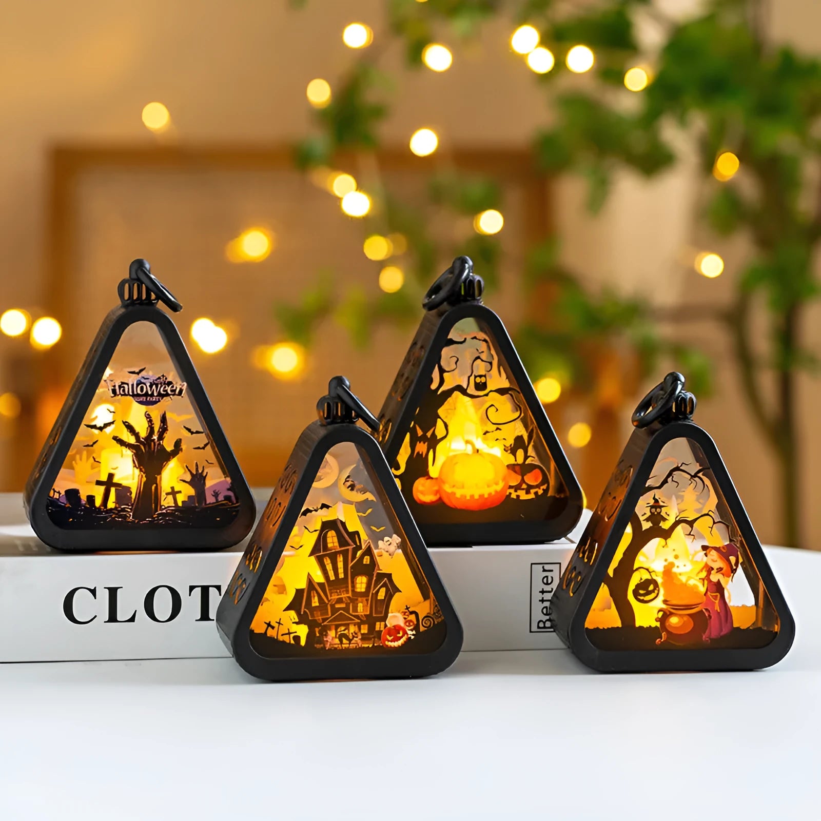 Portable Halloween pumpkin lamp decoration in choice of four colours on a table.