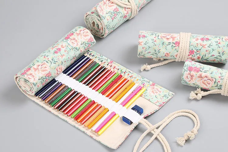Canvas pencil wrap roll up case with multiple elastic bands holding pens and pencils, in a compact roll.