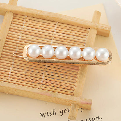 Slip-on pearl bow hair clip in alloy with flower at 2.4cm and pearls up to 7.2cm, secure grip design