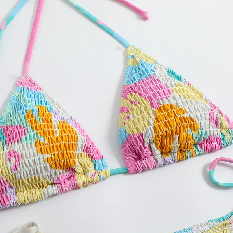 Women's triangle bikini swimsuit with floral gradient pattern and smocking craft detailing