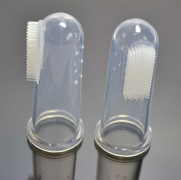 Silicone pet toothbrush set in white color, with finger-fit design for easy use and soft bristles for gentle cleaning of cats' and dogs' teeth.