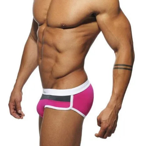 Men's nylon patchwork swim trunks in black with brief cut for swimming