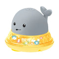 Grey and white cartoon whale bath toy spraying water with LED lights glowing