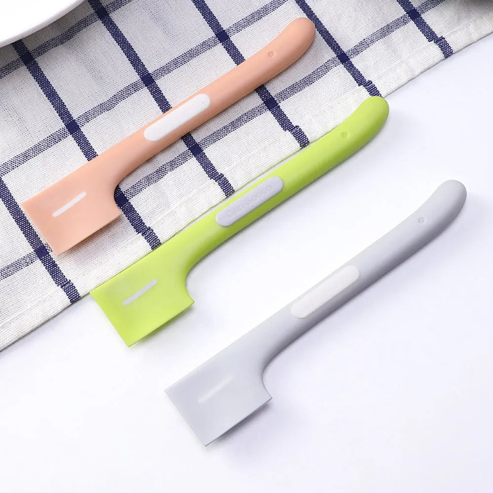 Green TPR pet feeding spoon with a long 16cm handle and right-angle scoop for canned wet food.