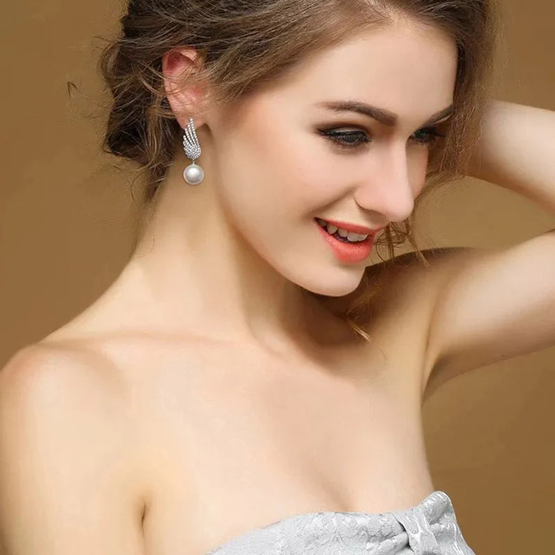 Platinum colour angel wing earrings with gemstone settings on diamond-treated silver