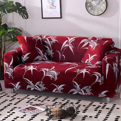 Printed stretchable sofa slipcover covering a three-seater sofa in a modern geometric pattern