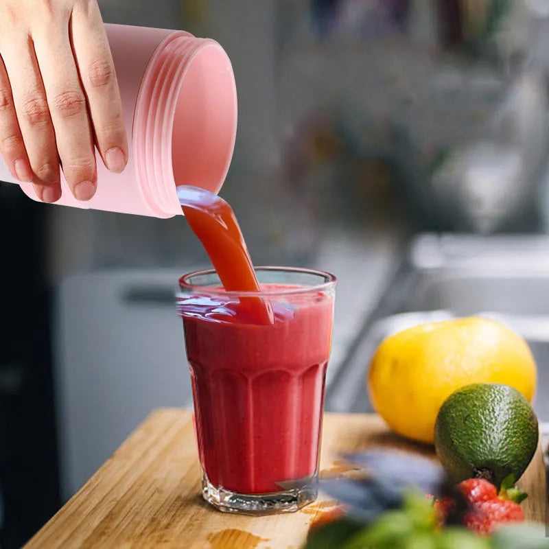Blue mini portable blender with stainless steel blades, shown extended and folded next to a USB cable.