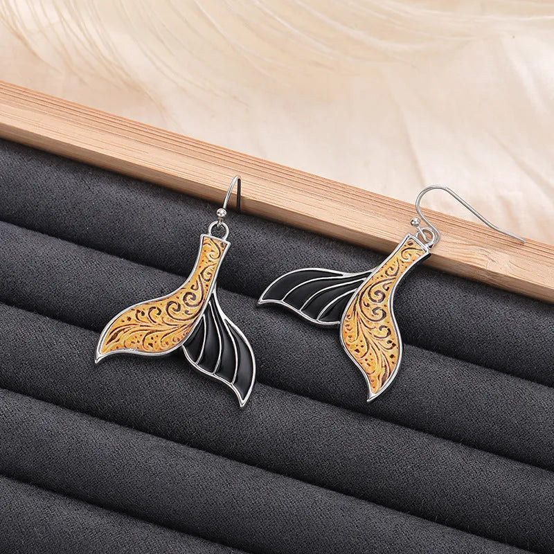 Women's white gold-colour fishtail earrings with whale design elements in retro style