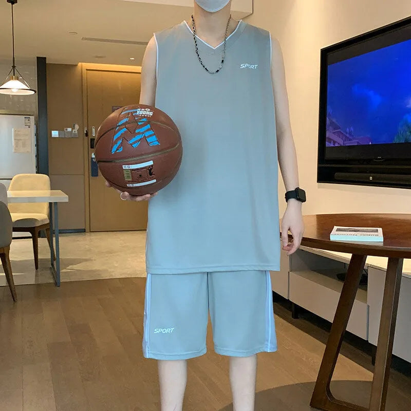 Men's white sleeveless basketball vest and matching shorts sportswear set laid flat.