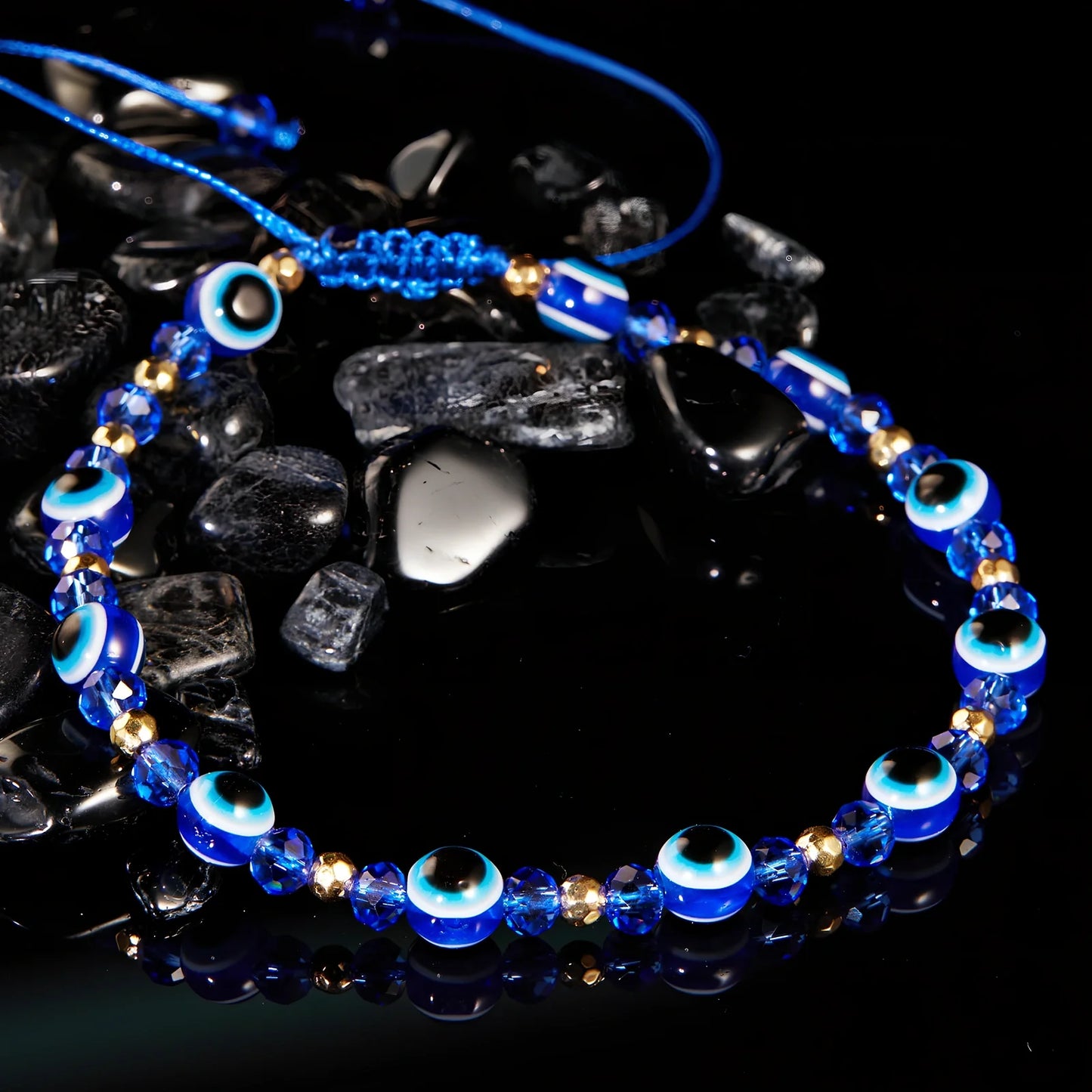 Adjustable crystal bead bracelet with blue eye design on braided rope, fits 15-19cm wrists