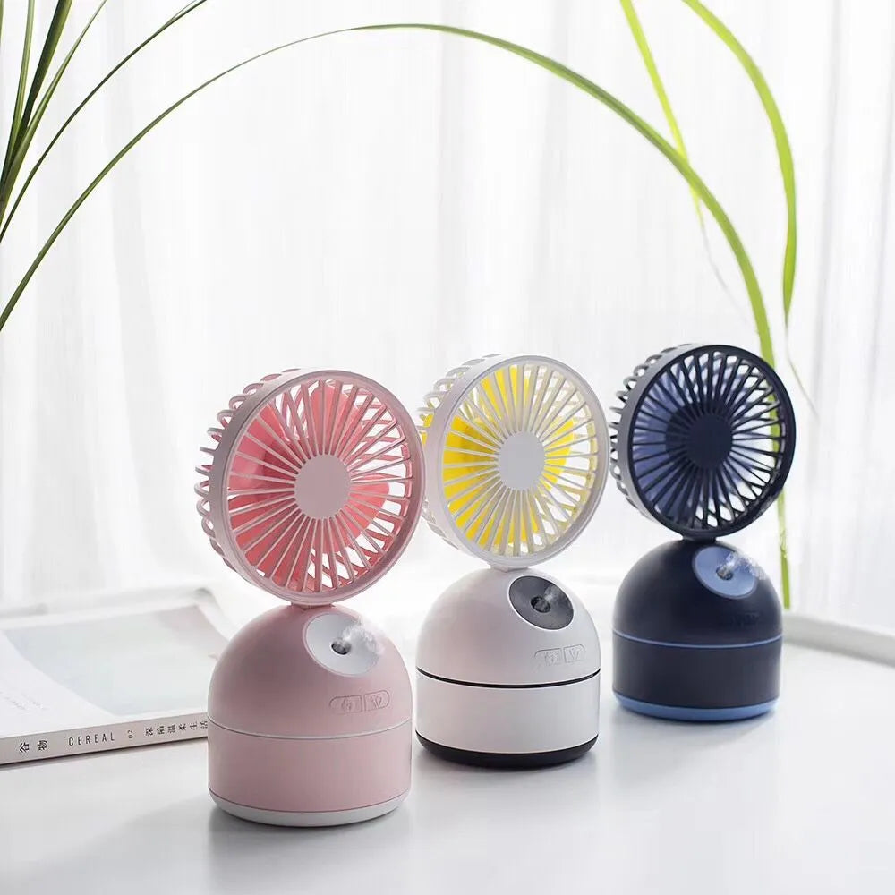 Portable USB fan humidifier in white with cool mist output and integrated fan, placed on a desk