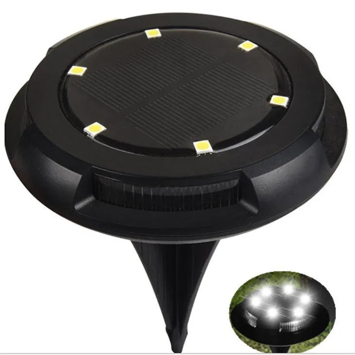 LED solar underground lawn light 11x4x13cm black ABS PP with seven colour changing cold white light on grass at dusk
