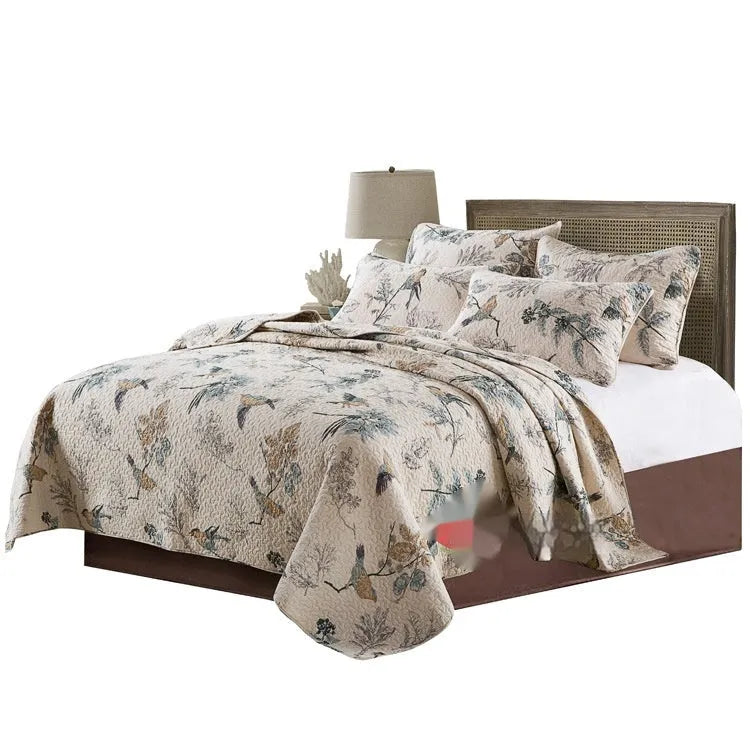 Quilted pure cotton bed cover and pillowcase set with printed pattern on a bed.