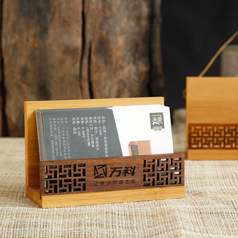 Geometric bamboo and black walnut business card holder on a desk