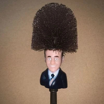 Bright yellow Trump-themed toilet brush with hanging slot