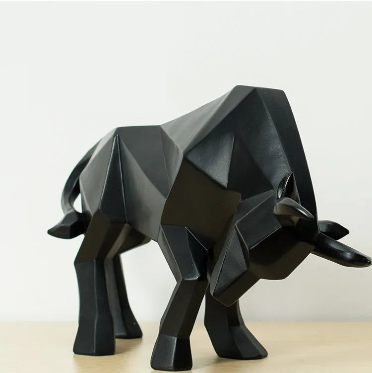 Modern geometric resin bull sculpture in black with abstract angular design on a neutral background