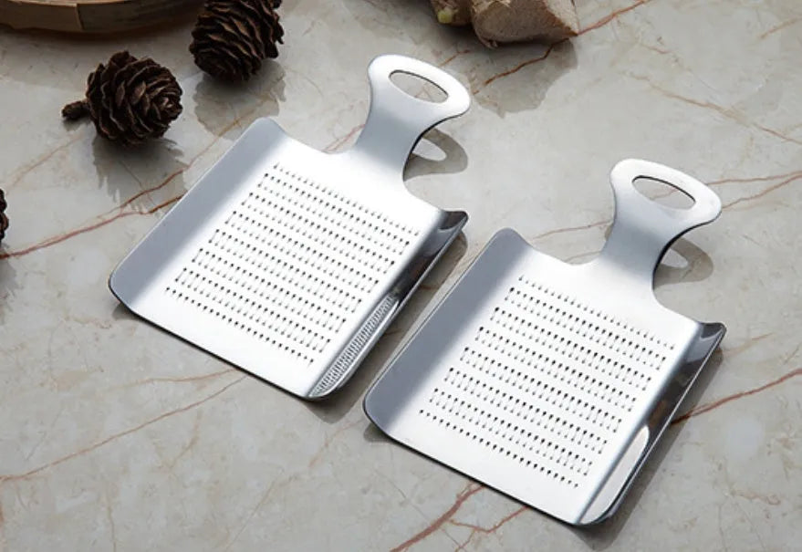 Silver 304 stainless steel garlic press with ergonomic ABS handle on a kitchen counter