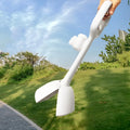 White plastic pooper scooper with clip shovel design for dog waste pick-up on grass