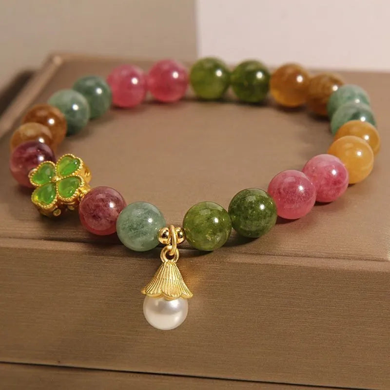 Coloured tourmaline bracelet with four-leaf clover pearl charm and geometric drop beads